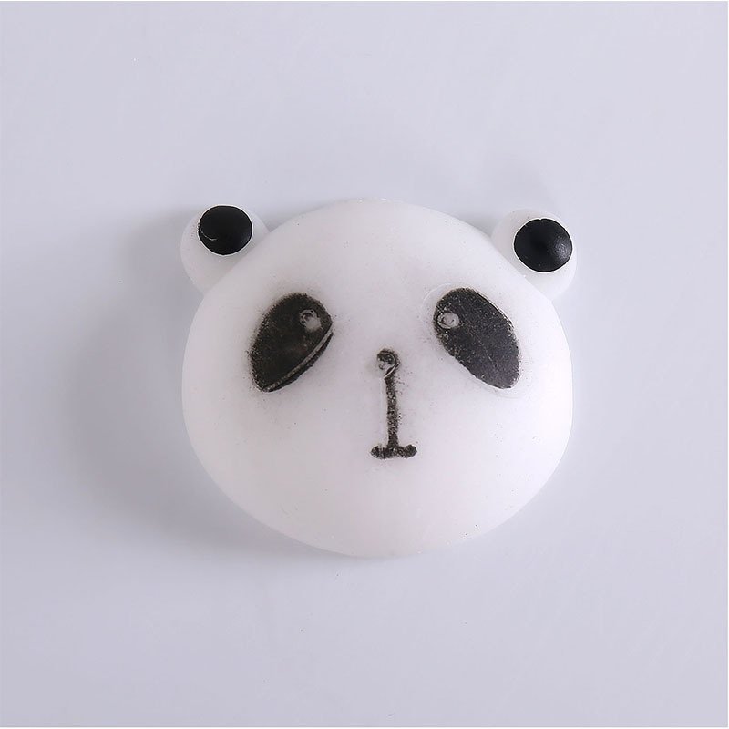 A small panda-face mochi squishy with black ears, oval eye patches and a simple nose-and-mouth detail